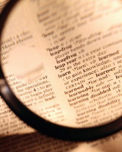 Magnifying Glass over Dictionary