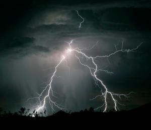 Lightning strikes near the town of Searchlight, Nevada as the first storm of the season passes through the western deserts of the United States in the early hours of June 8, 2006. (REUTERS/Gene Blevins)