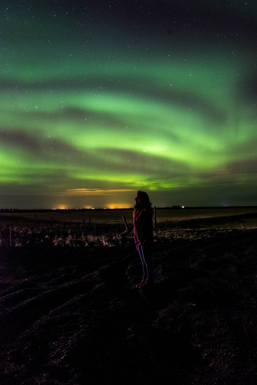 person looking at the northern lights