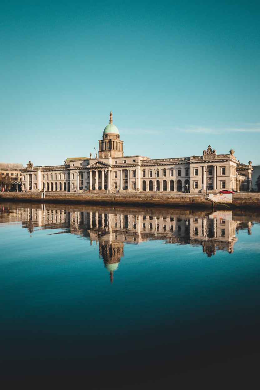 white concrete building beside the body of water